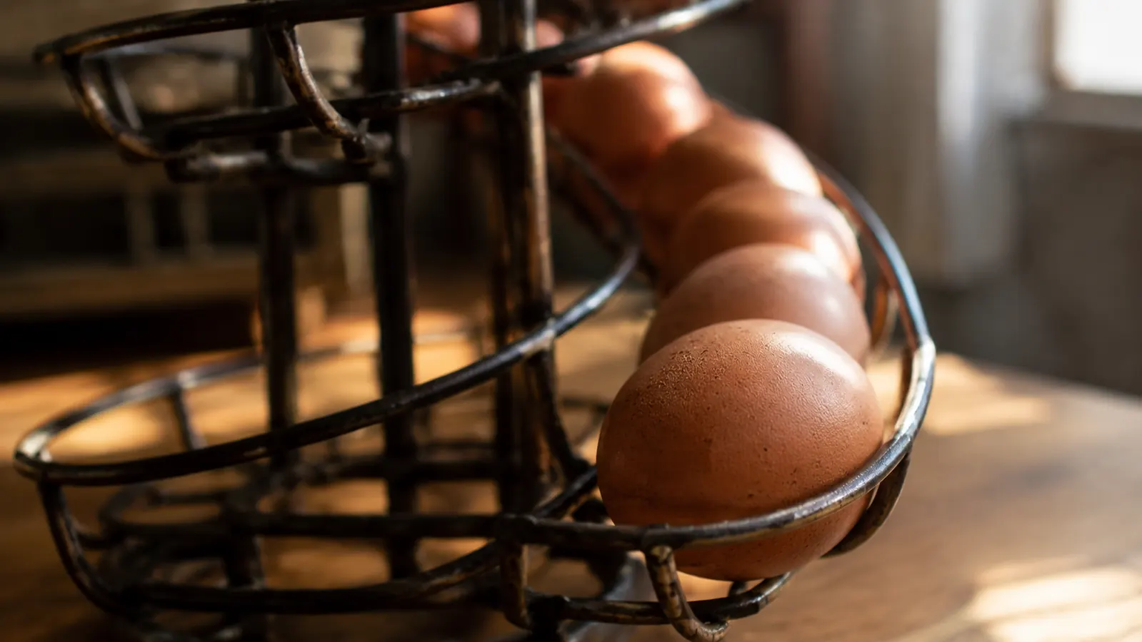 A close view of eggs lined up one by one along the spiral track of the skelter with the oldest egg at the front